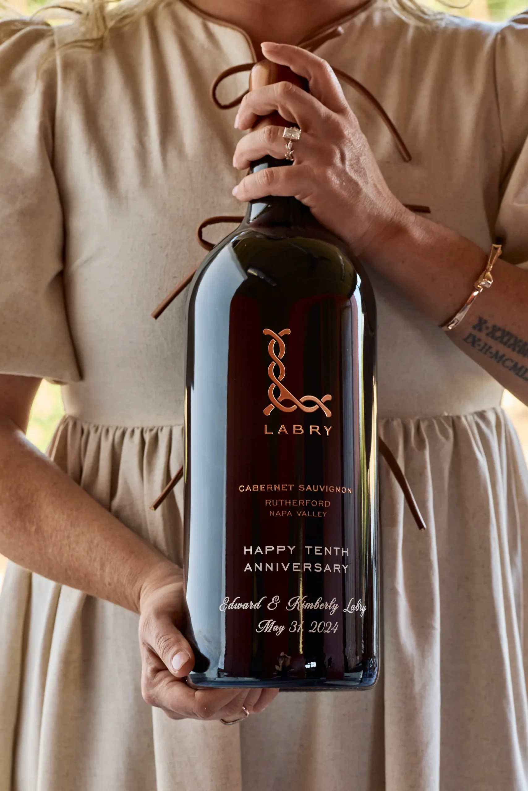 large format bottle Woman holding a magnum bottle of Labry Cabernet Sauvignon with custom etching